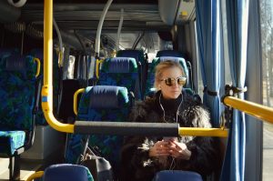 Girl with headphones on bus