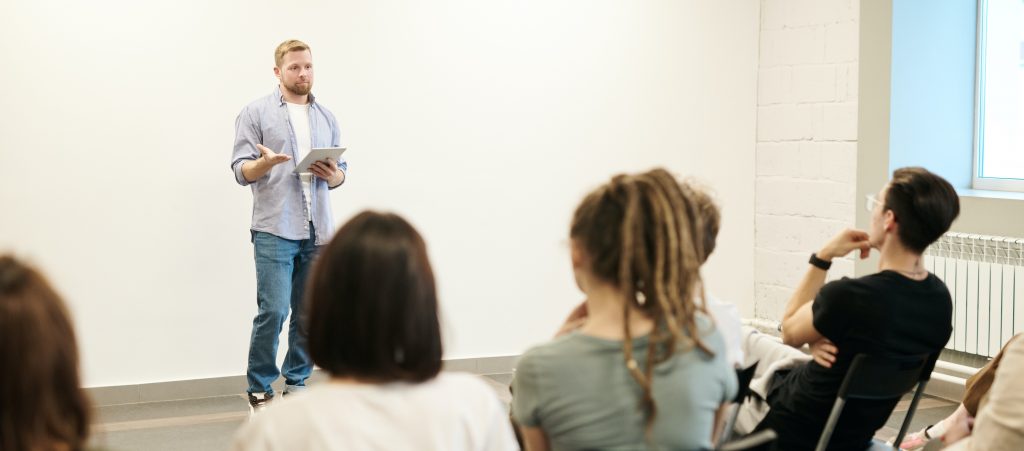 Man speaking in front of class