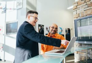 Two men looking at laptop