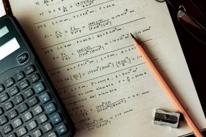 Calculator laying on page of maths equation