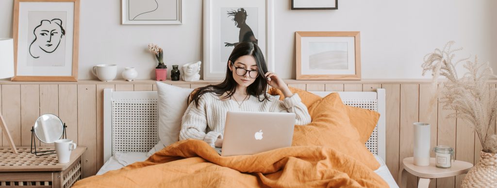 Woman in bed with laptop