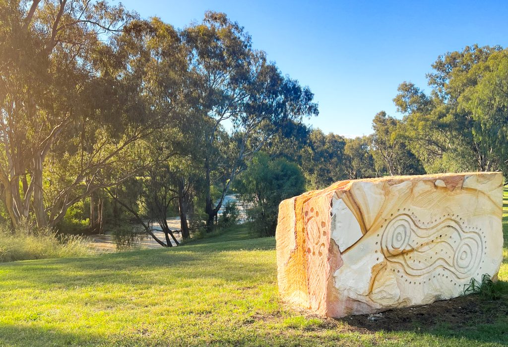 Photo of a rock with Aboriginal art on it.