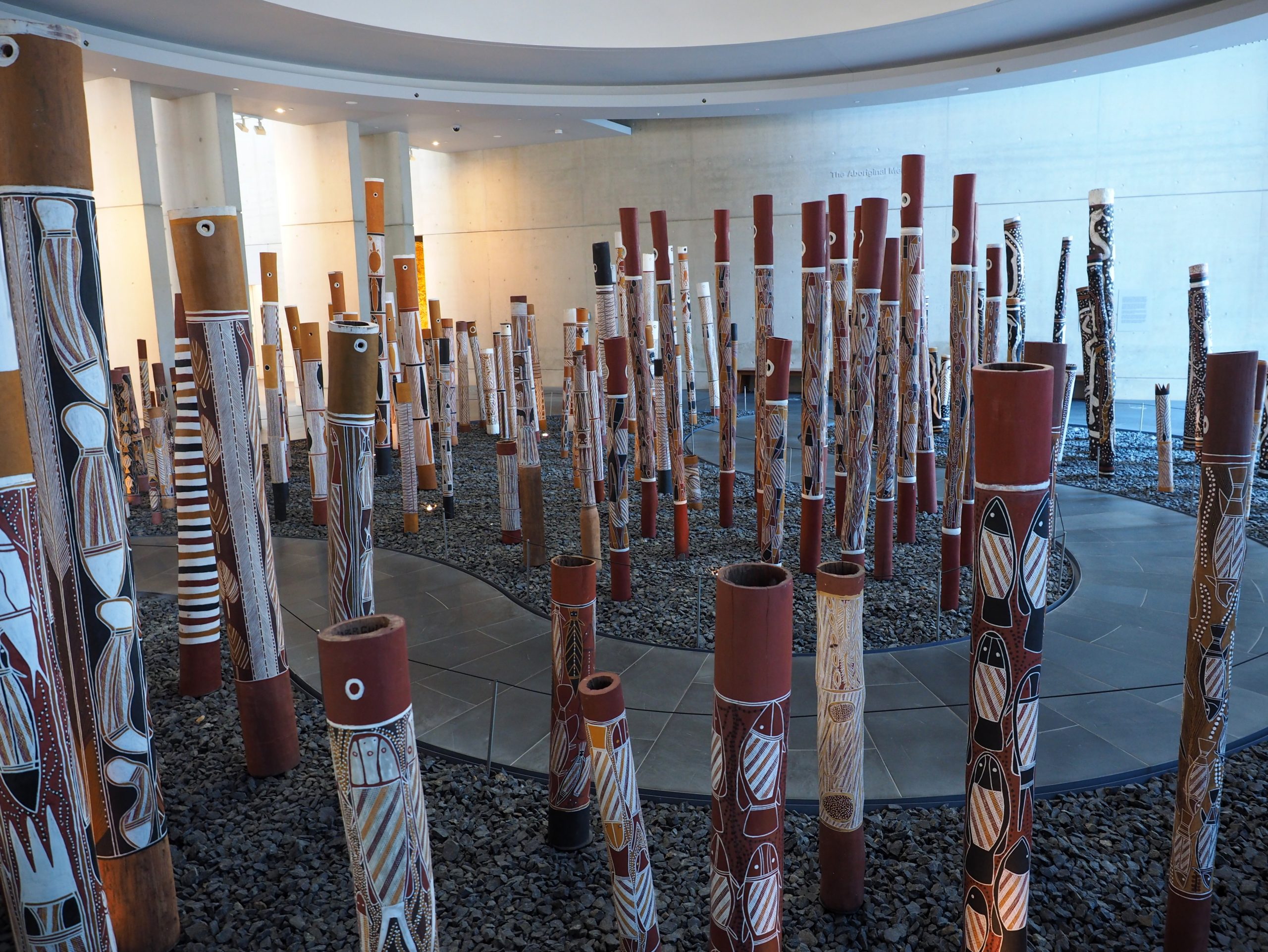 boriginal Memorial viewed from the foyer of the National Gallery of Australia. It's a collection of logs painted with aborginal art
