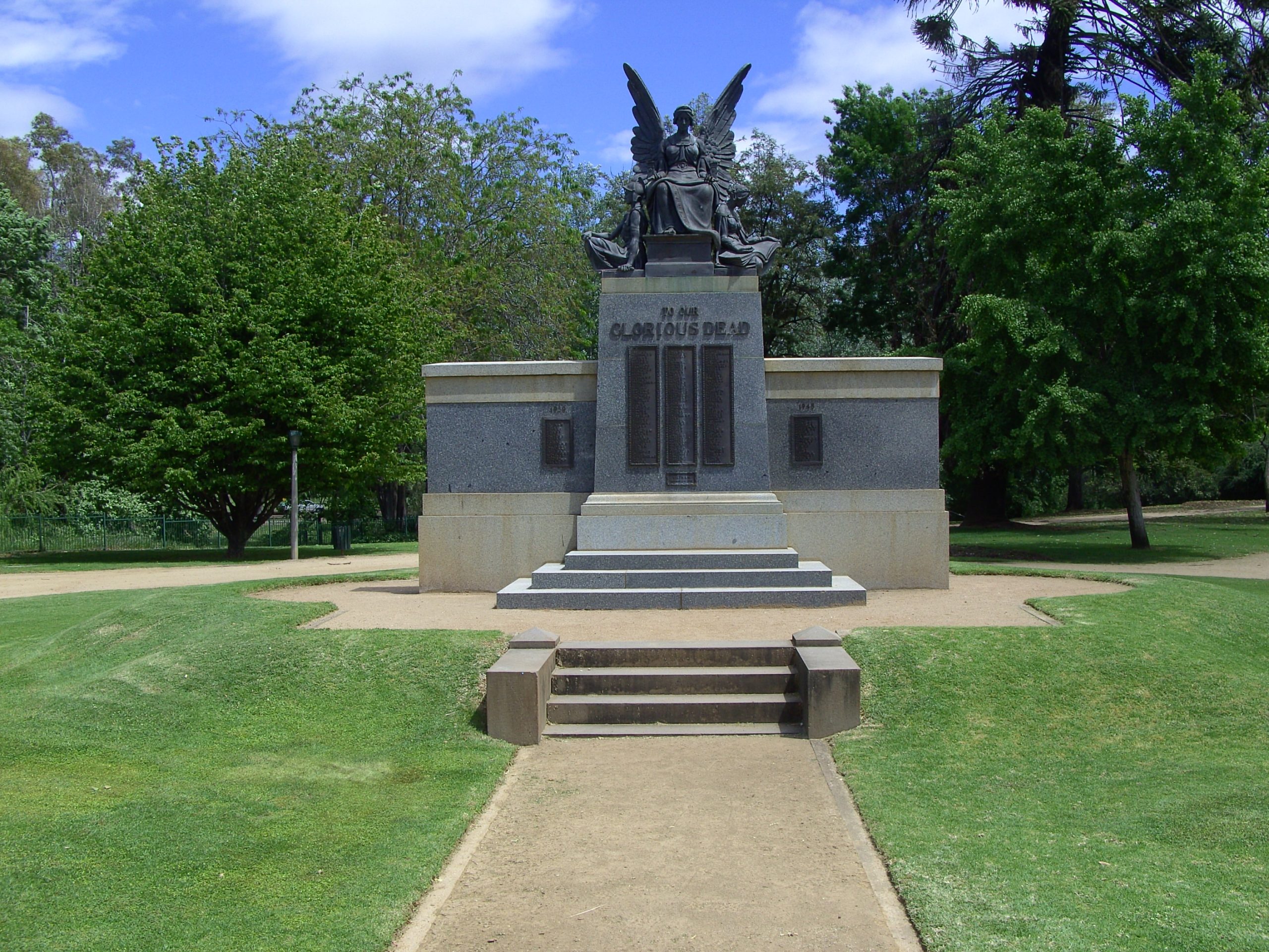 Photo of black and grey ANZAC memorial from the front of road.