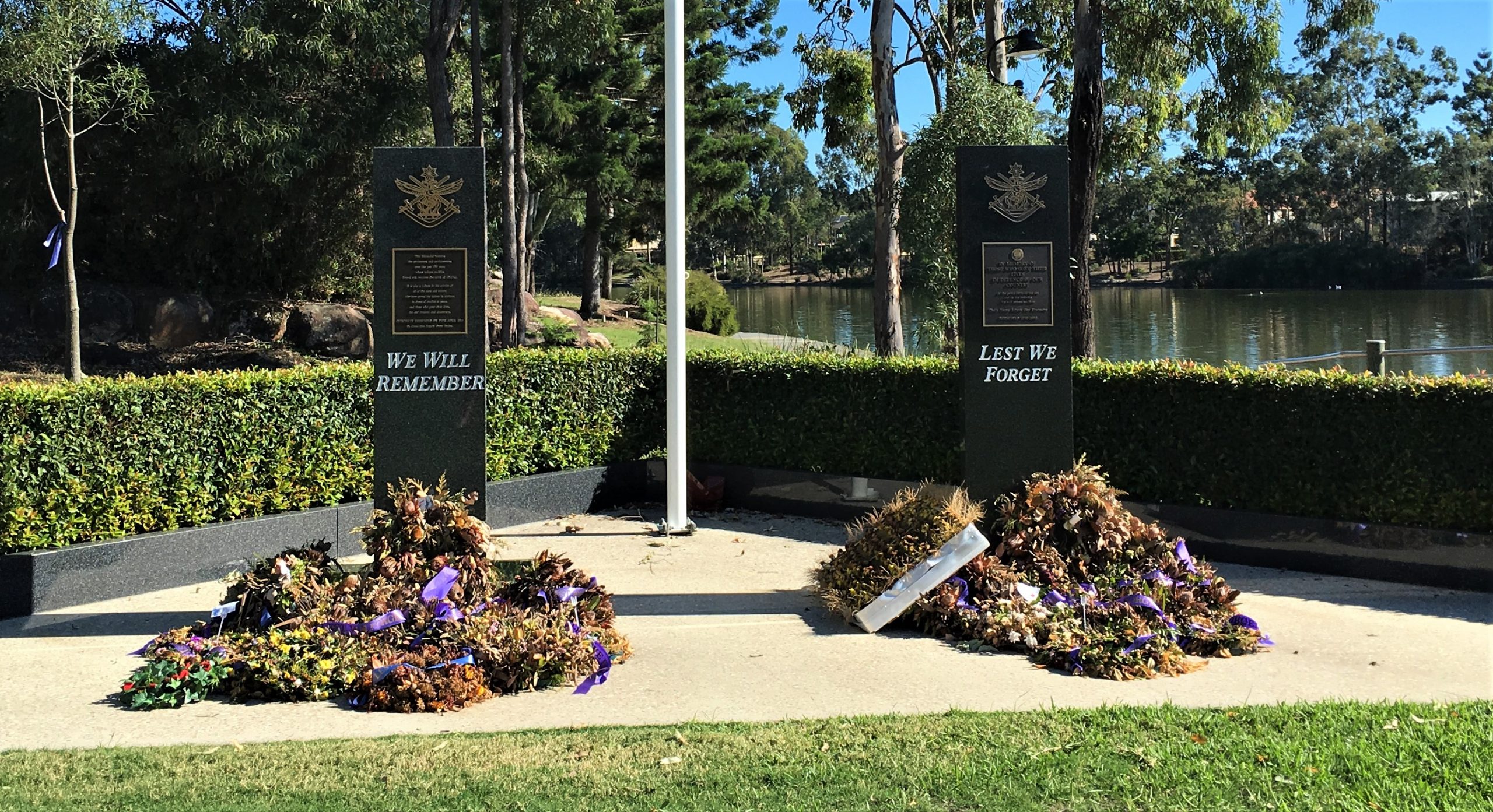 Remaining wreaths left from Anzac Day 25 April at the war memorial beside the lake at Forest Lake.