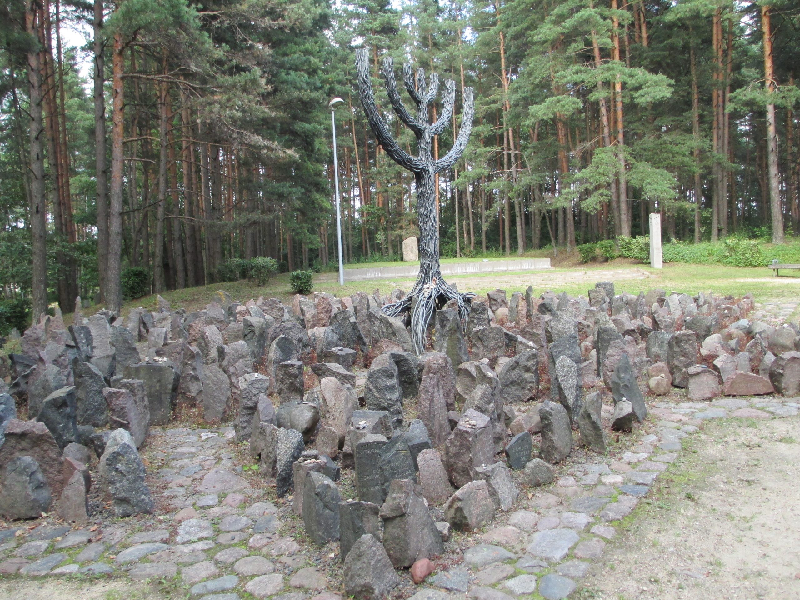 A memorial that looks like a pile of rocks surrounding a tree