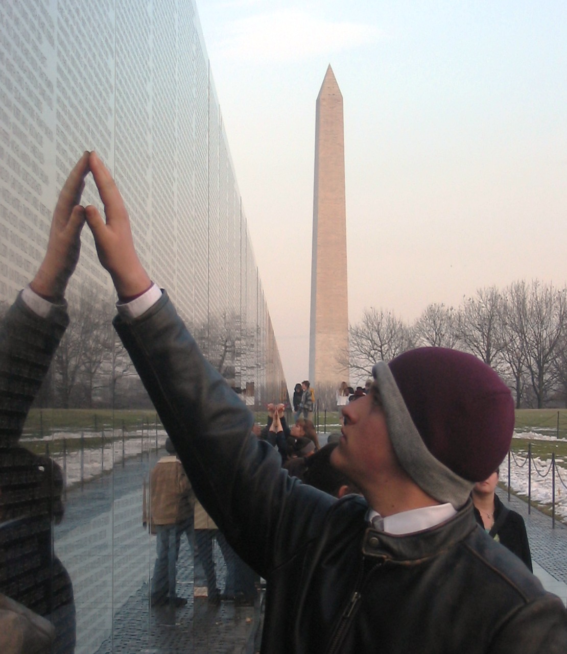 A visitor touching a name on The Wall at the Vietnam Veterans' Memorial