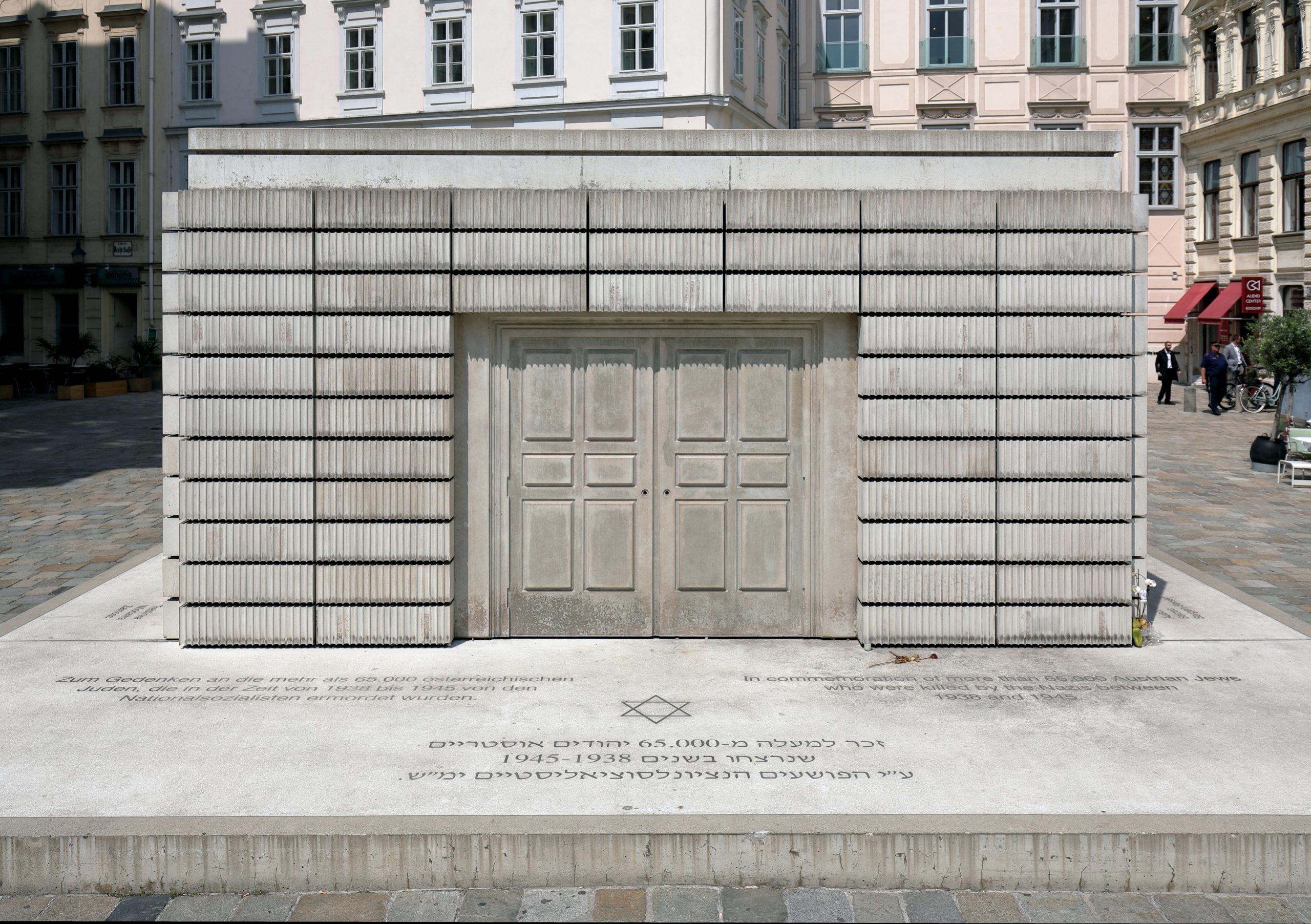 A white memorial building made of what looks like book spines