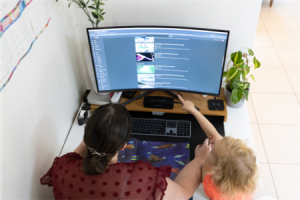 woman and child looking at computer with child pointing at the screen