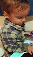 child choosing pictures in a book