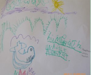 child's drawing of humpback whale with clouds, sun and waves and child and adult writing of 'humpback whale habitat'