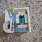 lego model of bathroom with shower, sink and bathtub in white and blue