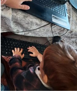 Toddler with hands on keyboard