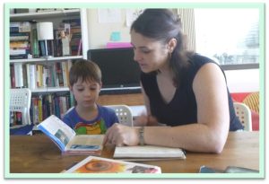 woman and boy looking at books together
