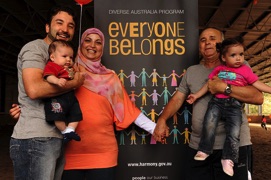 Muslim family next to sign that says everyone belongs