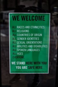 A poster on a door saying we welcome all everyone