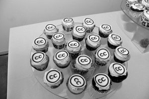 Black and white photo of cupcakes with CC logo as icing