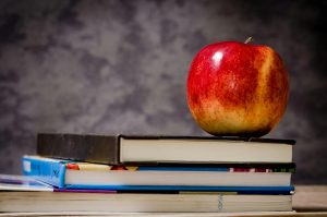 An apple on a pile of books