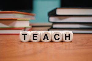 The word teach made of scrabble blocks