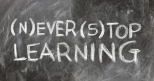 A decorative image of a blackboard with the words 'never stop learning'.