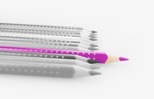 A decorative image of a row of grey pencils in a neat line. One purple pencil stands out from the line.